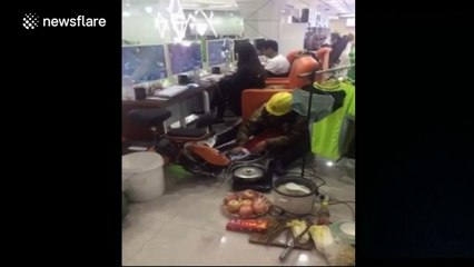 Man does housework in internet cafe while his wife plays computer games