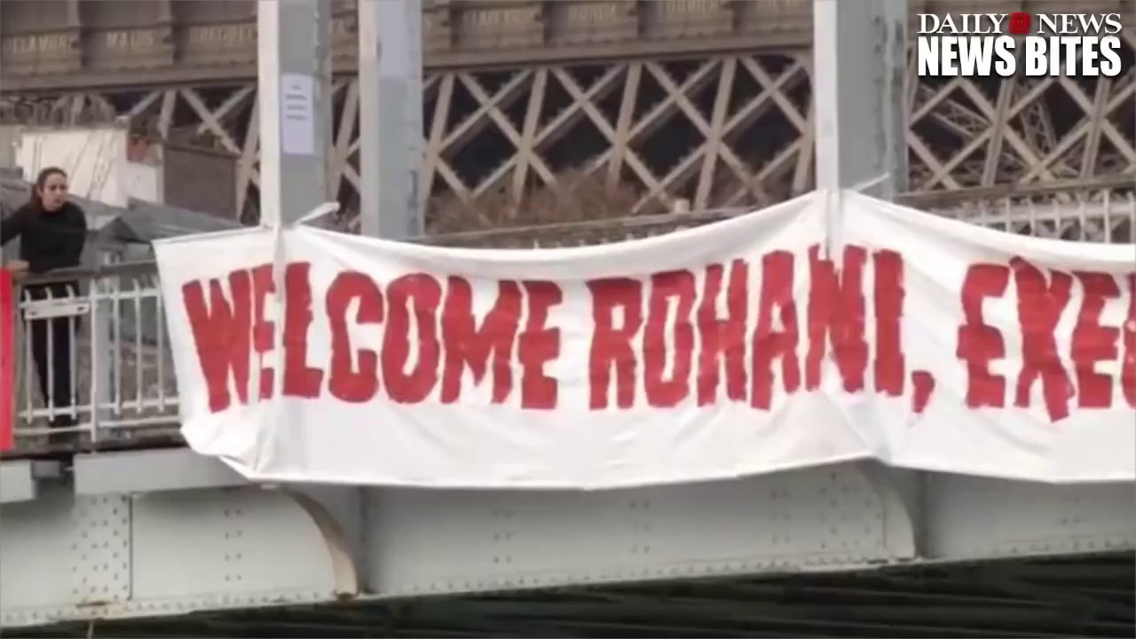 Topless Woman Hangs From Paris Bridge in Protest