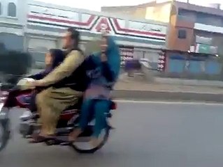 Boy wheeling on Bike with his Girl Friend