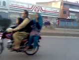 Boy wheeling on Bike with his Girl Friend