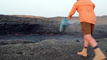 Drum of water into Erta Ale lava lake
