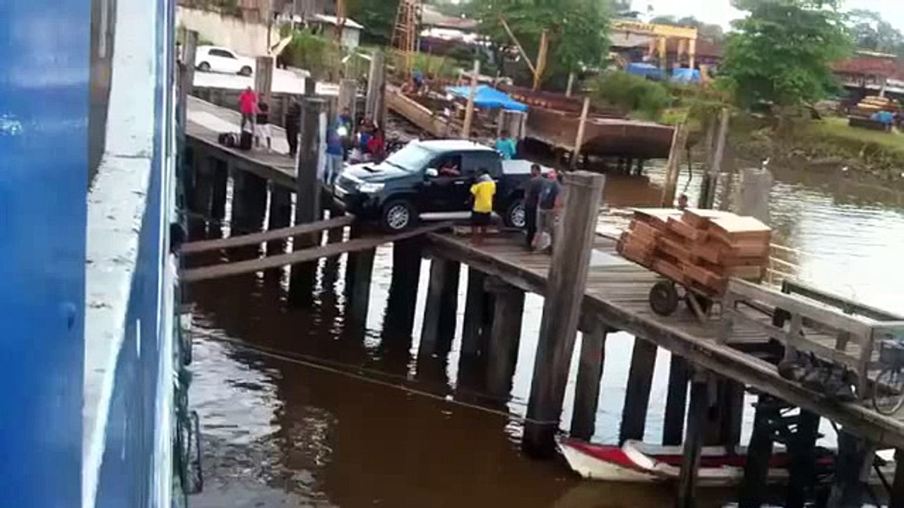 Crazy guy boards a truck using a wood board