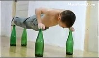 Small Boy Doing Push Ups on beer bottles