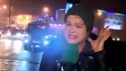 Reporter gets hit by traffic stop sign in high wind conditions
