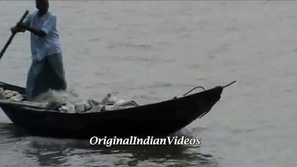 Old man middle of the ganga river in a boat