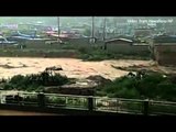 Vehicles washed away as China road collapses