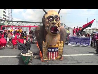 Protesters burn an effigy of President Aquino