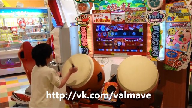 Japanese kid shows great skills playing on drums in arcade video game
