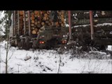 Fully loaded Volvo timber truck stuck in mud, Valtra A93 helps