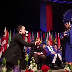 A man proposes during a graduation ceremony