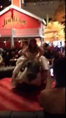 Bride rides mechanical bull in wedding gown