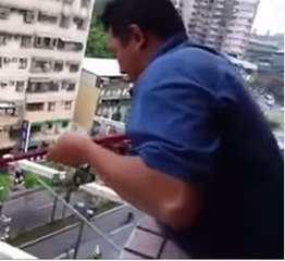 A man catches a fish from the 8th floor