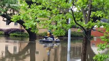 Firefighters on jet skis on the flooded streets of Houston