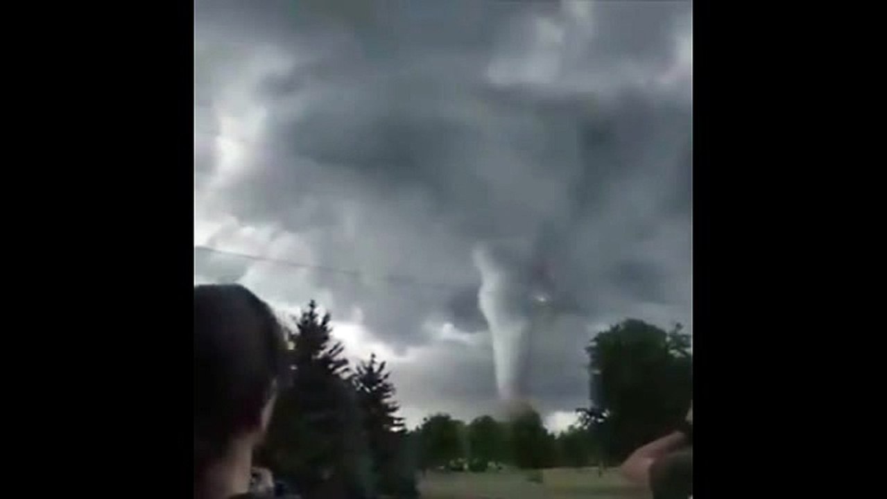 A tornado picks up cars as it crosses a busy road