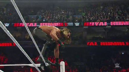 Seth Rollins hits a flying elbow drop onto the announce table- S