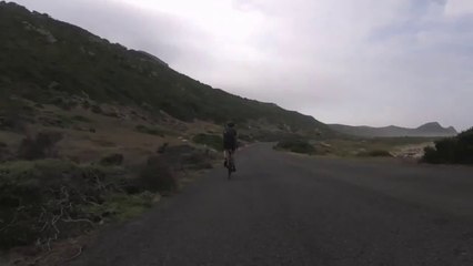 Cyclists chased by an ostrich in Africa