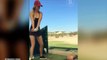Pro golfing pin up girl Paige Spiranac practices her tee shot off a mans FACE