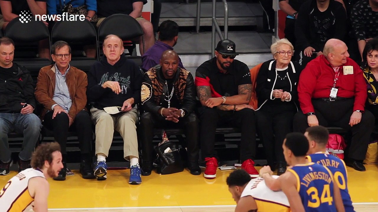Rihanna watching the LA Lakers courtside at the Staples Center