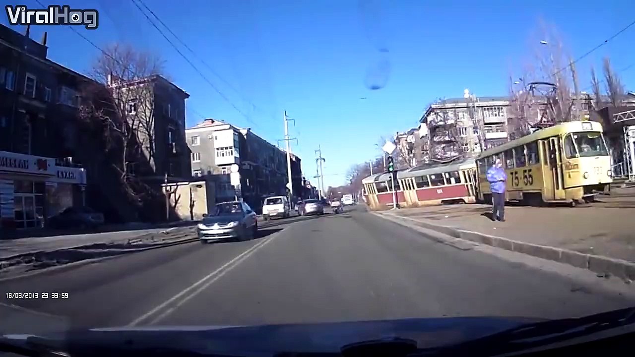 a scary moment as a tram derails and collides with a pedestrian