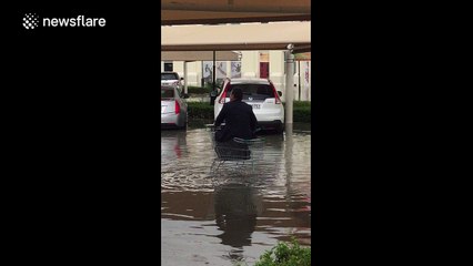 Man rides shopping trolley in bizarre attempt to avoid Dubai floodwater