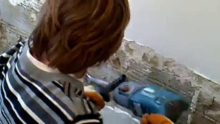 Sam smashing tiles off wall