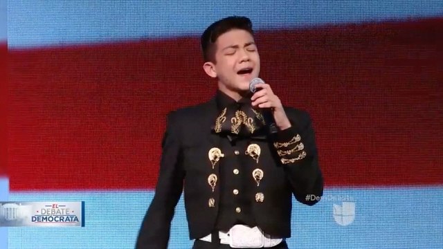 Boy who endured racist attacks sings national anthem at Democratic debate