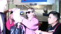 Actress January Jones signs autographs for fans as she arrives at LAX Airport