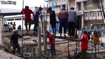 These construction workers show they don't need heavy machinery to set a foundation
