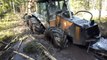Valtra forestry tractor with big, fully loaded trailer in wet forest