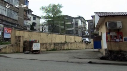 Driver tries to reverse, smashes through wall