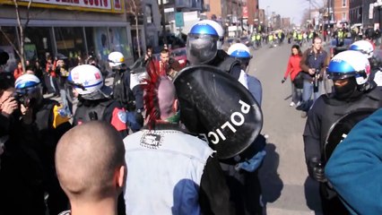 A Punk Sporting A Bright Red Mohawk Confronts Riot Police During COBP Protest