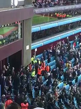 Aston Villa stewards wrestle anti-board banner from fans during Spurs defeat