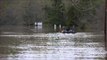 Men Fish on Flooded Louisiana Road