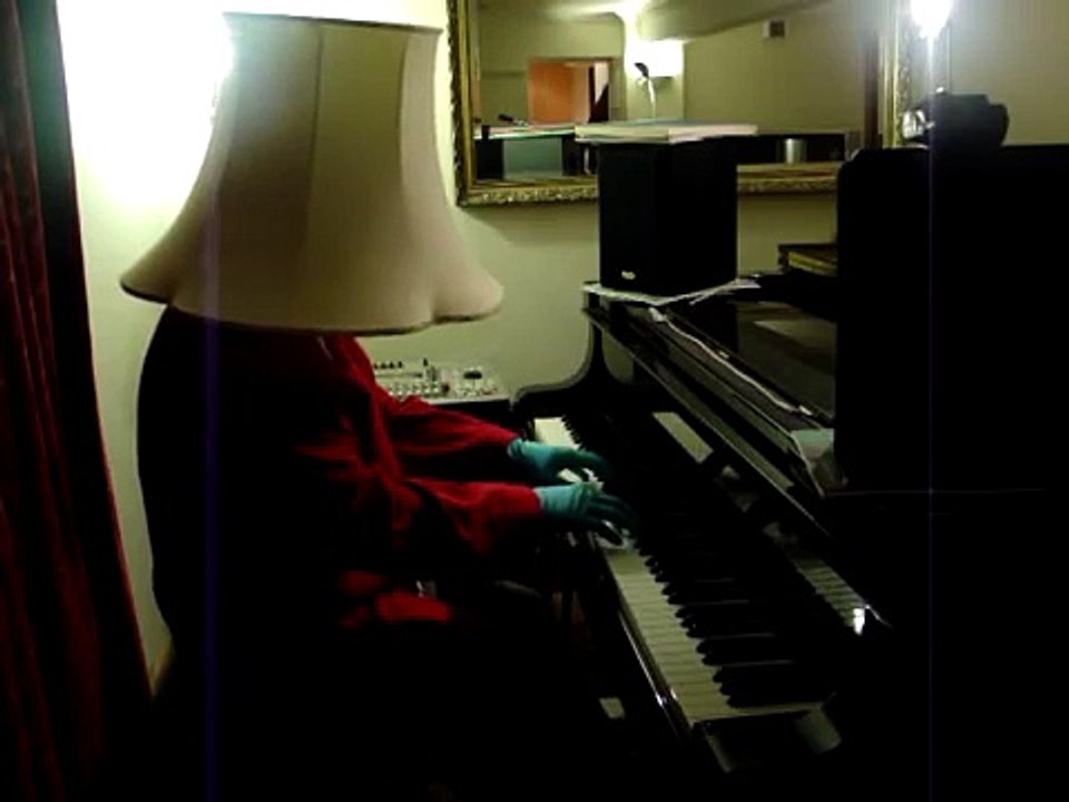 Piano with lamp shade on head