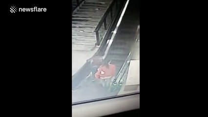 Man saves the day after woman and child fall over on escalator