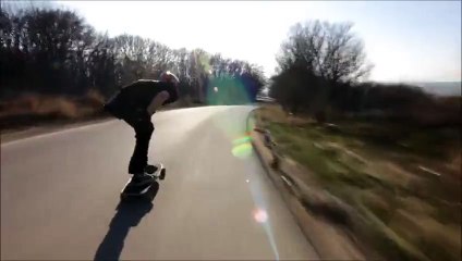 Un rider en longboard se prend une voiture à pleine vitesse