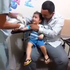 child laughing while doing his treament