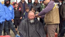 Artist Ai Weiwei gets haircut at Idomeni migrant camp