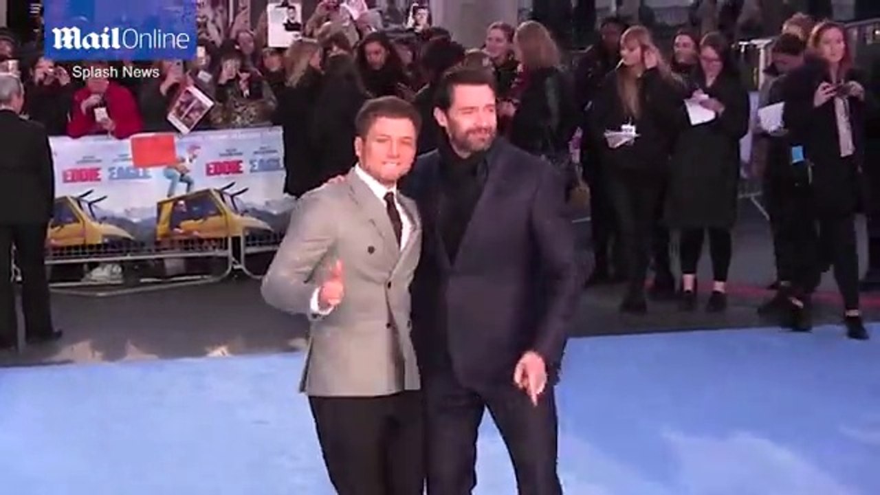 Hugh Jackman and Taron Egerton joke around at premiere