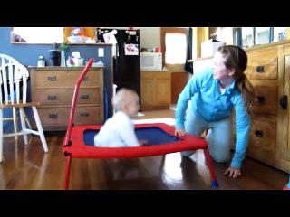 Adorable baby loves jumping on trampoline