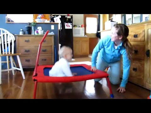 Adorable baby loves jumping on trampoline