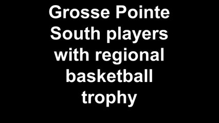 Grosse Pointe South players with regional basketball trophy