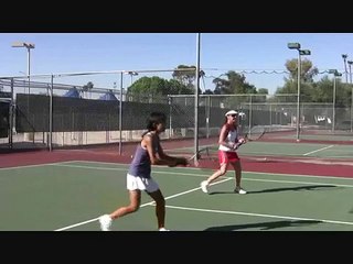 Coach Tim Barnes is on the tennis court, interacting with students