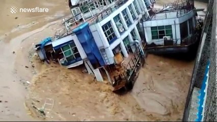 Abandoned barges crash into China bridge after rainfall