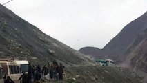 Passengers stuck in buses on the Karakoram Highway survive huge boulders raining down a mountain slope in the Kohistan D