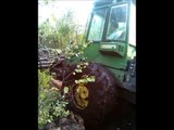 John Deere 1010D with full trailer of wood stuck in mud, extreme