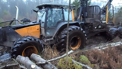 Valtra forestry tractor, difficult road in wet forest