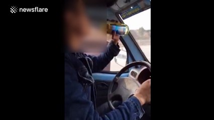 Man appears to drink beer casually while driving