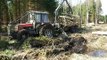 Belarus Mtz 1025.2 forestry tractor with full trailer of wood stuck in mud,difficult condi