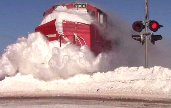 Train Plows Through Massive Snow Bank